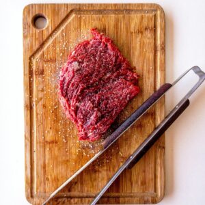 Brown Wooden Chopping Board With Meat On Top